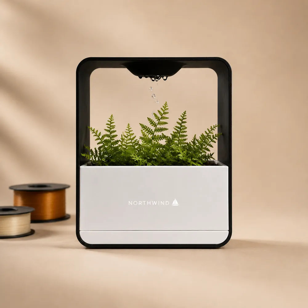 Self-watering desk planter with a sample company wordmark printed on the front, beside filament colour swatches